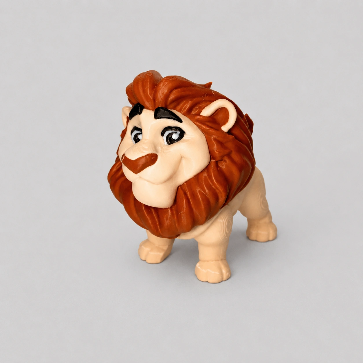 Stylized toy lion figure on a gray background.